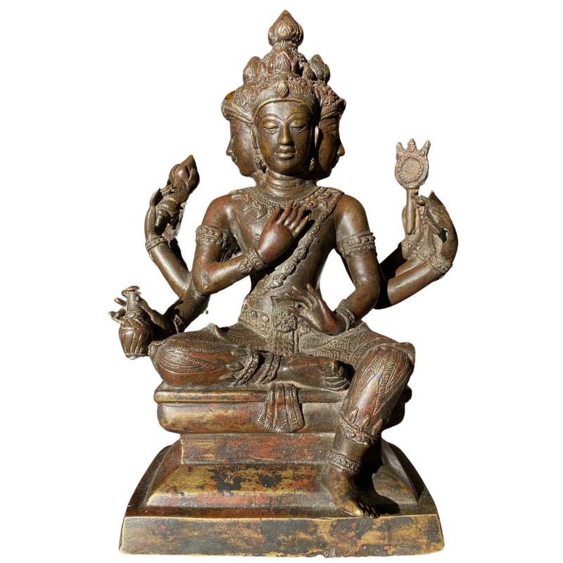 Fire-gilded bronze Brahma statue with four faces and six arms, seated on a pedestal