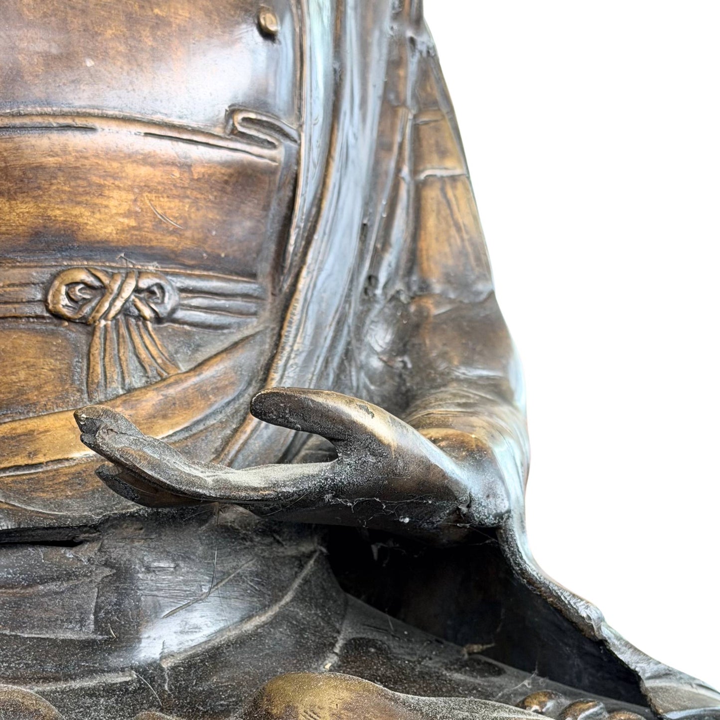 Detail of the hand mudra on a fire-gilded bronze Buddha with old patina, ritual significance, and fine finish.