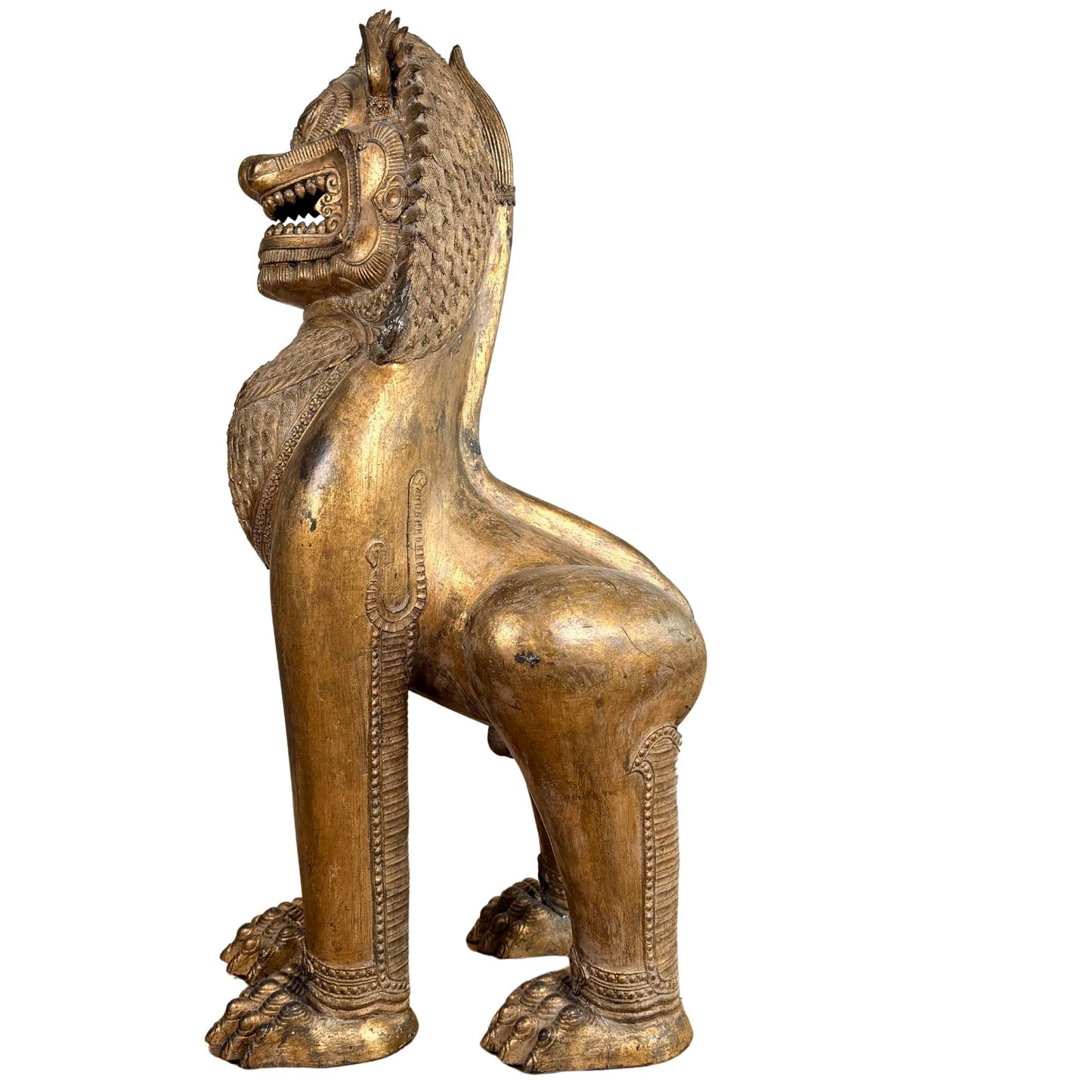 Fire-gilded Thai Singha lion, monumental antique temple statue with deep signs of age