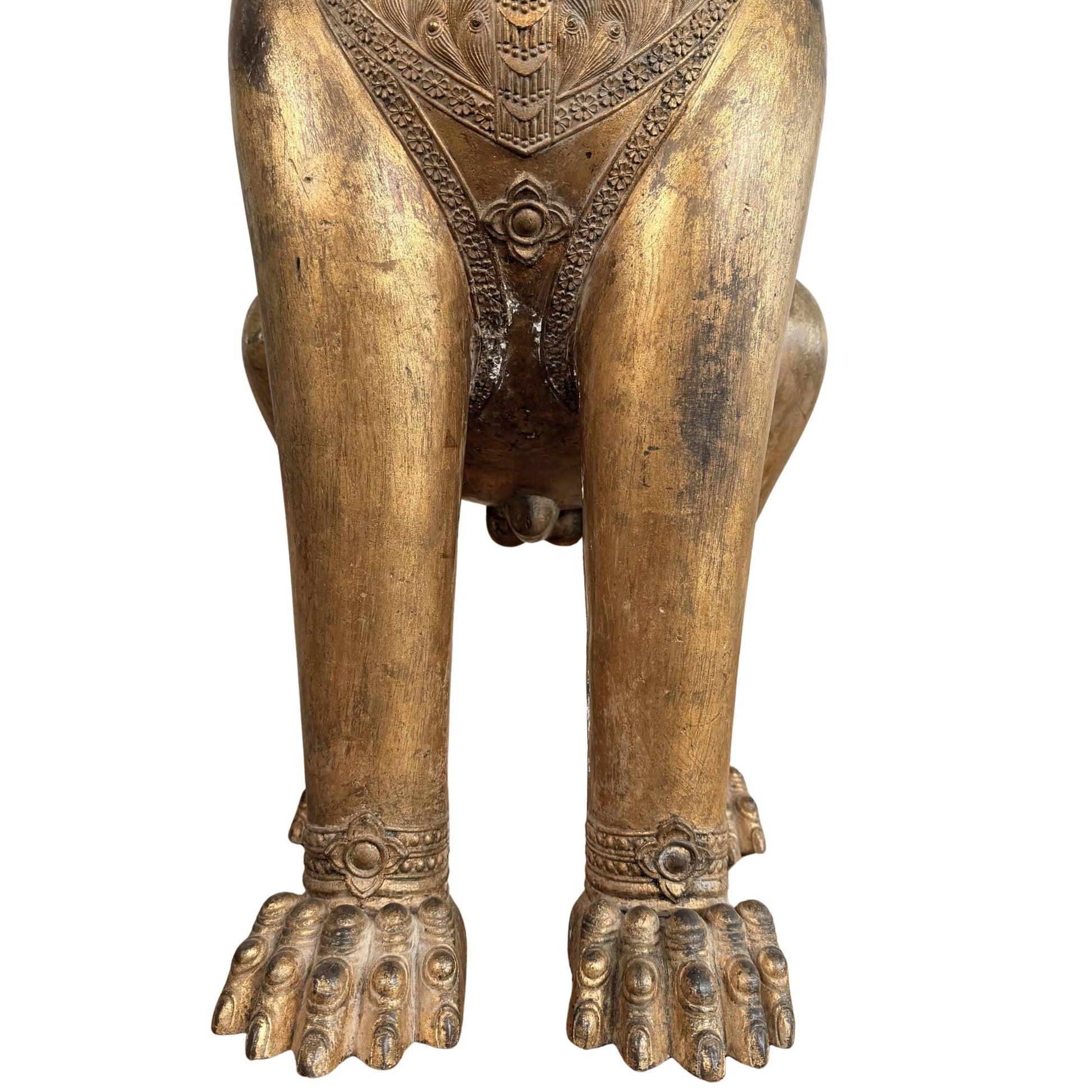 Rare Thai temple statue of a Singha lion, antique gilded guardian statue with spiritual significance and its forepaws