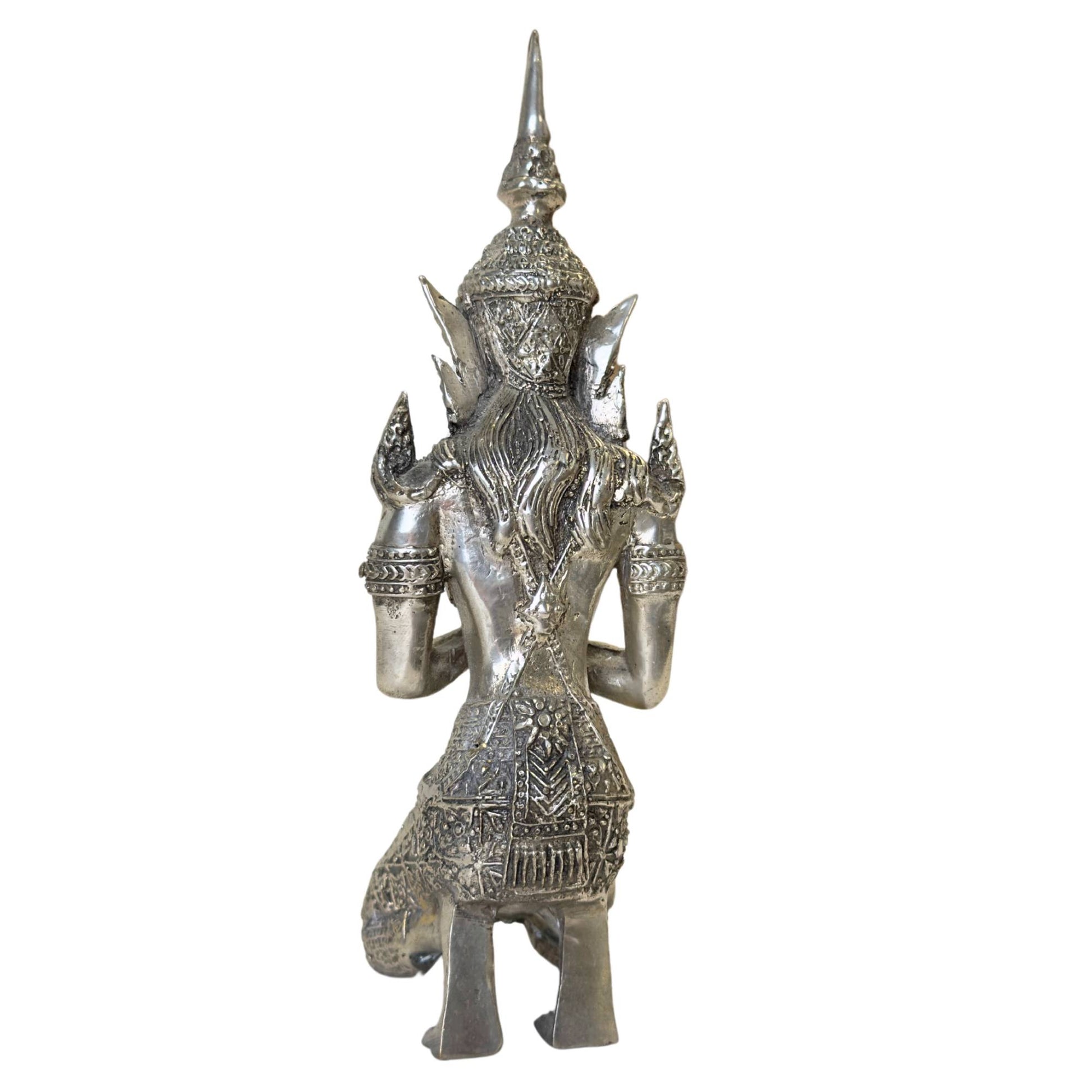 Profile of a kneeling Thepanom angel in traditional costume.