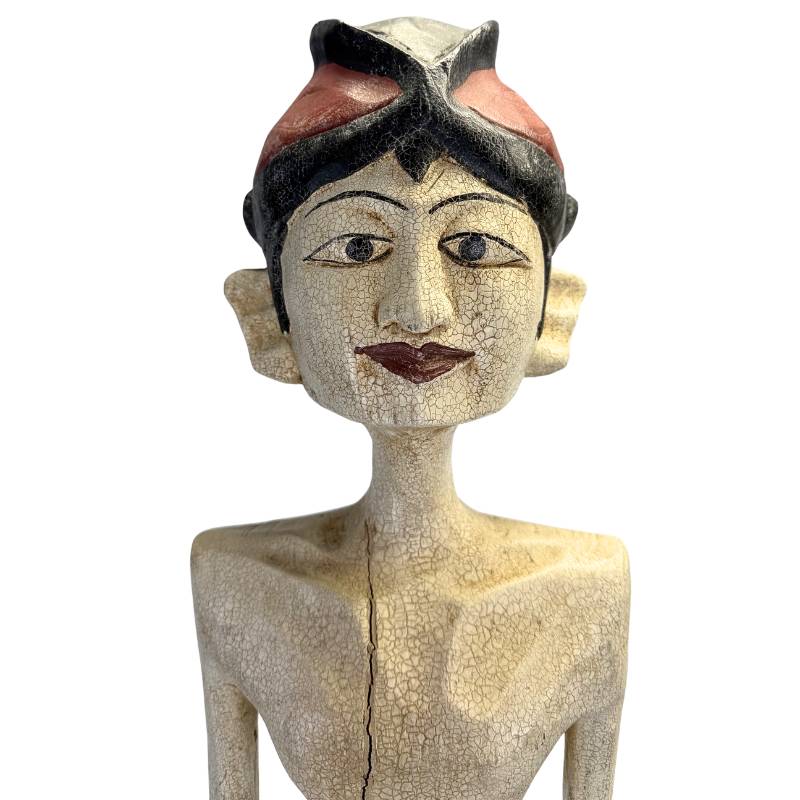 Side view of the slender, extruded verticality of the wooden figures.