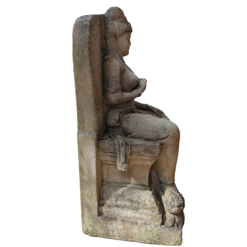 Side view of hand-carved Javanese goddess sandstone sculpture