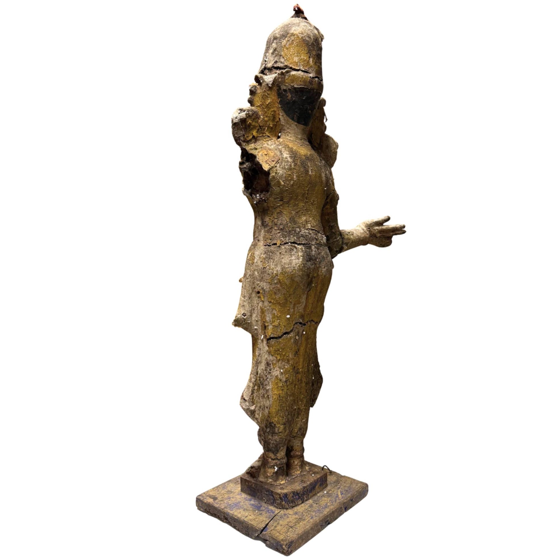 South Indian deity statue with glass decoration and weathered historical details