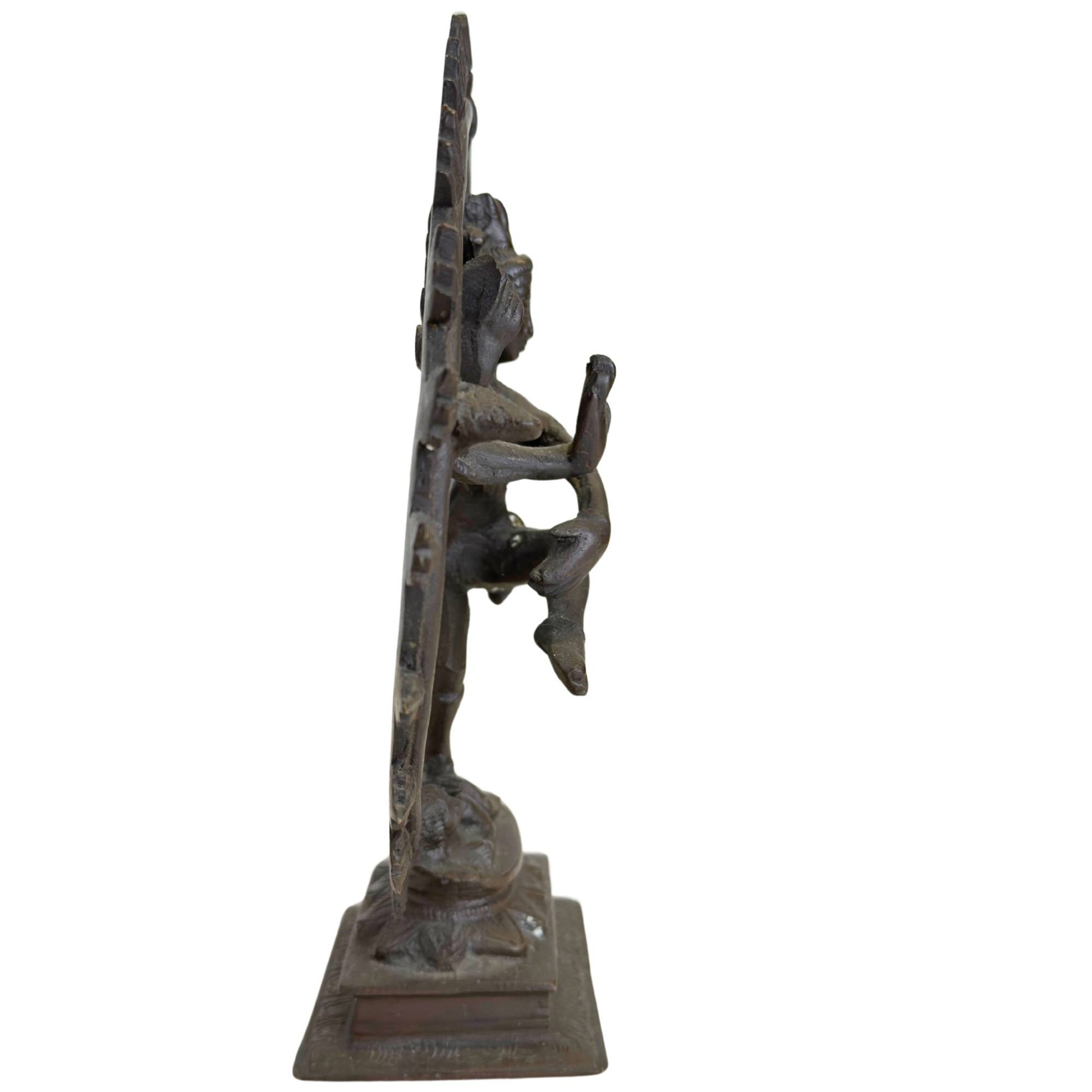 Heavy bronze Shiva statue in side view with traditional flame ring and graceful dancing pose